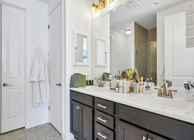 175 Christian Dr, Santa Rosa Beach, FL 32459 - bathroom with a sink, tiled shower, double vanity, and visible vents