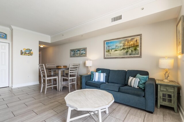 16819 Front Beach Rd Unit 1114, Panama City Beach, FL 32413 - living room with crown molding, wood tiled floors, and baseboards