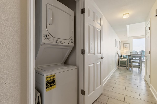 16819 Front Beach Rd Unit 1114, Panama City Beach, FL 32413 - washroom with stacked washer / drying machine and baseboards