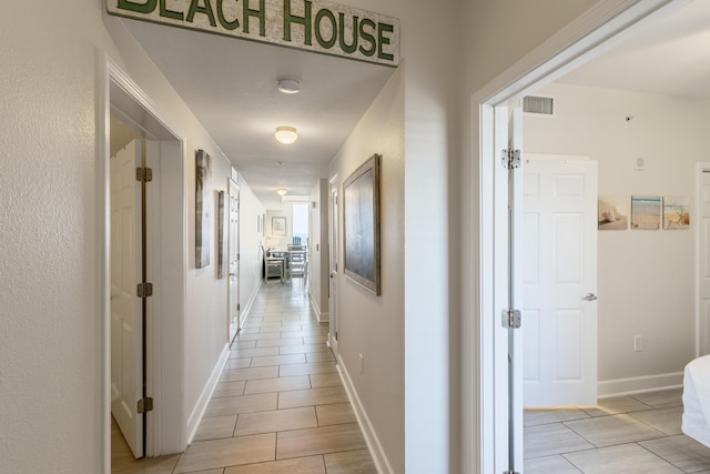 16819 Front Beach Rd Unit 1114, Panama City Beach, FL 32413 - hallway with light tile patterned floors and baseboards