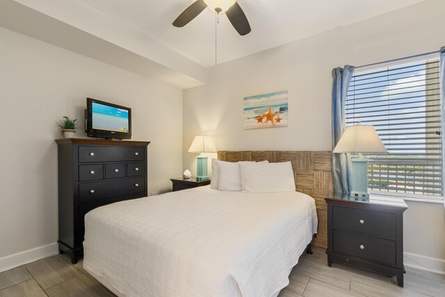 16819 Front Beach Rd Unit 1114, Panama City Beach, FL 32413 - bedroom featuring baseboards, wood finished floors, and ceiling fan
