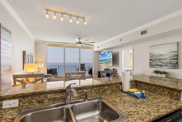 16819 Front Beach Rd Unit 2415, Panama City Beach, FL 32413 - kitchen with a sink, open floor plan, ornamental molding, a ceiling fan, and stone countertops
