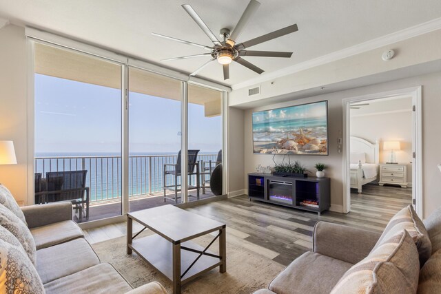 16819 Front Beach Rd Unit 2415, Panama City Beach, FL 32413 - living room featuring ceiling fan, wood finished floors, ornamental molding, and baseboards