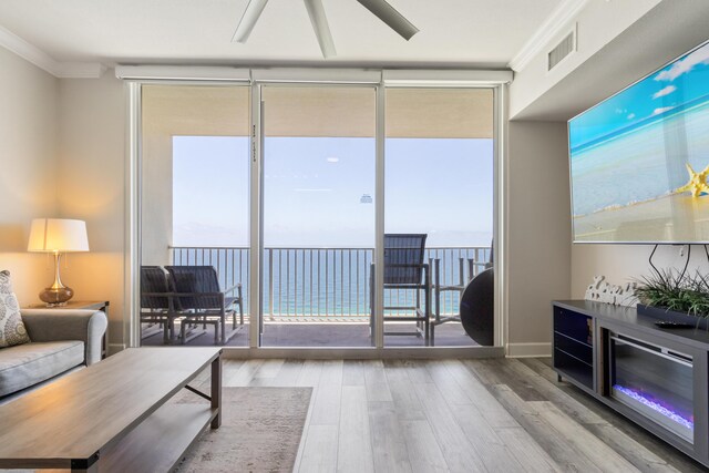 16819 Front Beach Rd Unit 2415, Panama City Beach, FL 32413 - living room featuring a wall of windows, wood finished floors, and crown molding