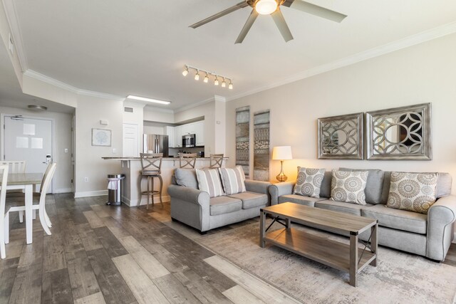 16819 Front Beach Rd Unit 2415, Panama City Beach, FL 32413 - living area featuring a ceiling fan, crown molding, wood finished floors, and baseboards