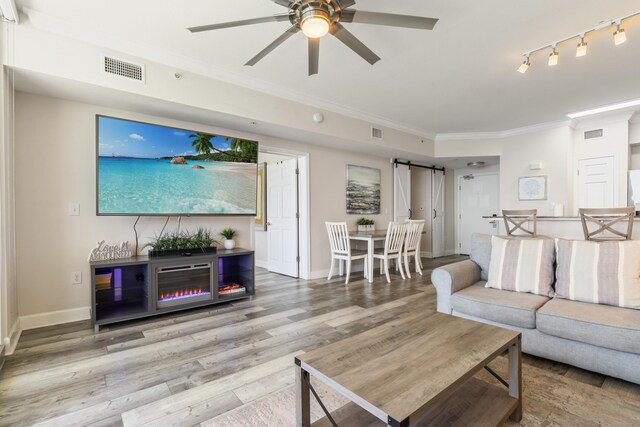 16819 Front Beach Rd Unit 2415, Panama City Beach, FL 32413 - living room with crown molding, a barn door, wood finished floors, baseboards, and ceiling fan