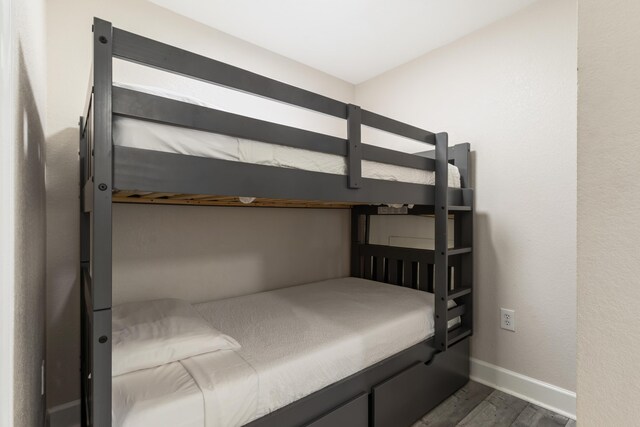 16819 Front Beach Rd Unit 2415, Panama City Beach, FL 32413 - bedroom with dark wood-style floors and baseboards