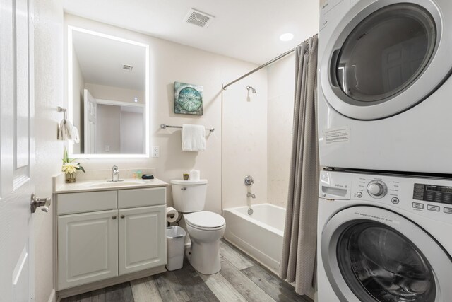 16819 Front Beach Rd Unit 2415, Panama City Beach, FL 32413 - bathroom with stacked washer / dryer, wood finished floors, toilet, shower / tub combo, and vanity