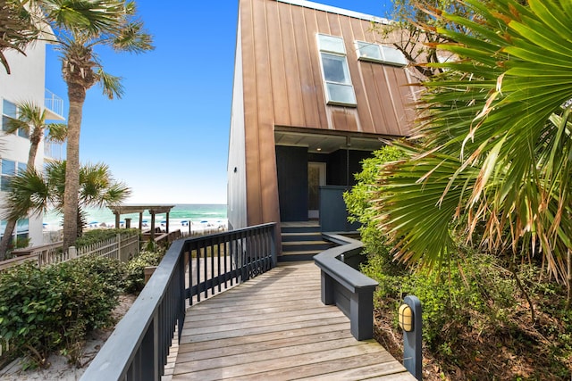 exterior space featuring a water view and a beach view