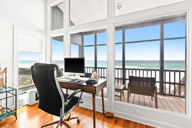 office area with plenty of natural light and wood finished floors
