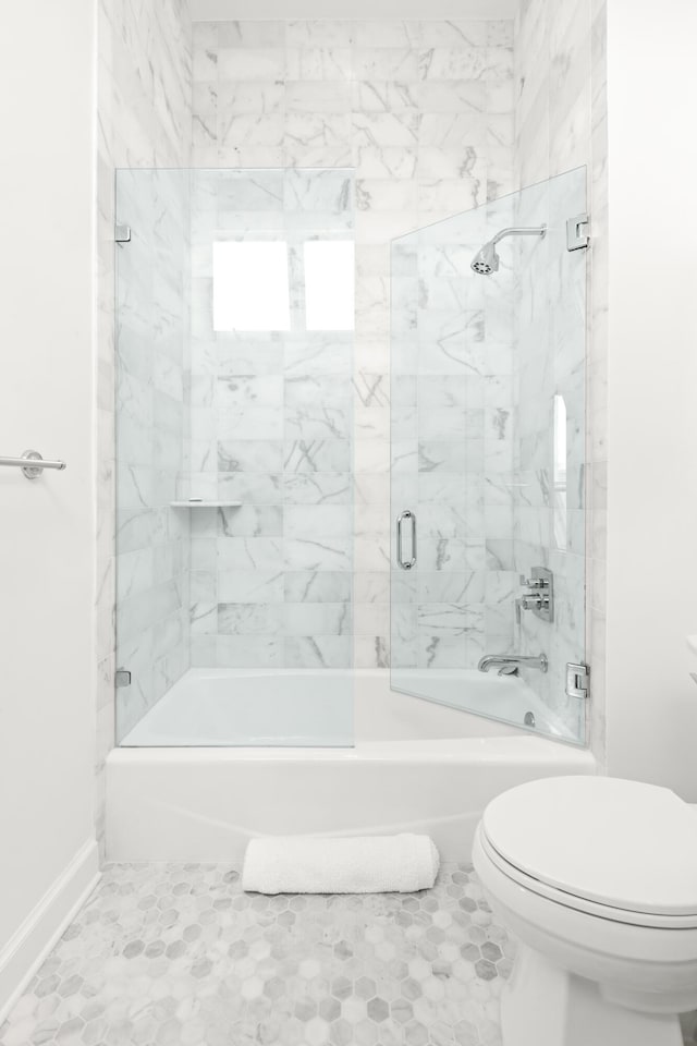 full bath with tile patterned floors, toilet, enclosed tub / shower combo, and baseboards