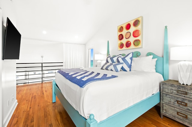 bedroom with vaulted ceiling, recessed lighting, and wood finished floors