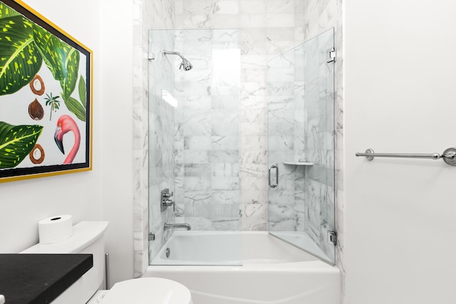 bathroom with toilet, vanity, and shower / bath combination with glass door