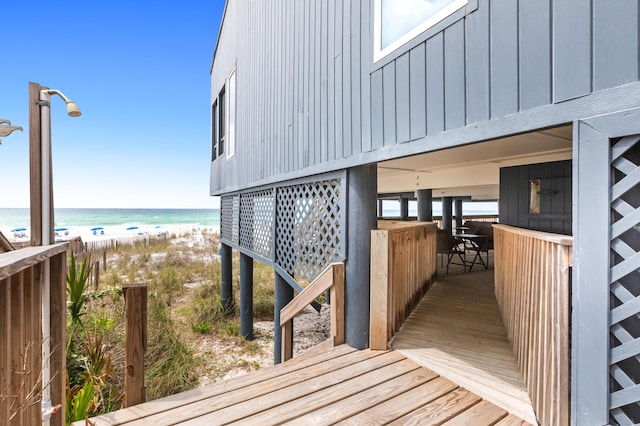 wooden terrace with a water view and a beach view