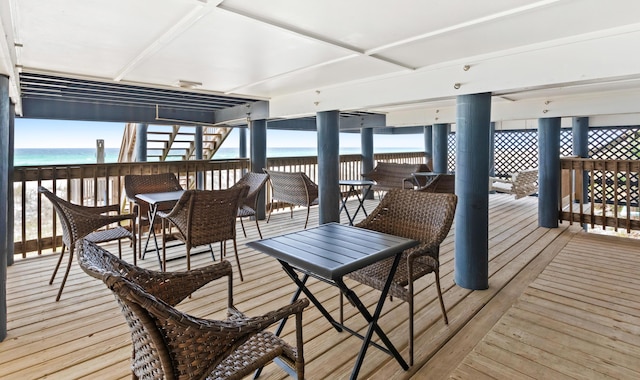 wooden terrace featuring a water view