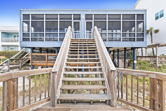 exterior space featuring a sunroom and stairs