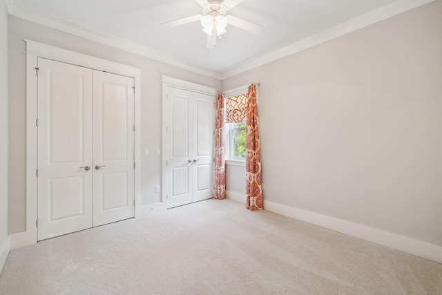 180 Blakely Drew Blvd, Santa Rosa Beach, FL 32459 - unfurnished bedroom with carpet, crown molding, baseboards, a ceiling fan, and two closets