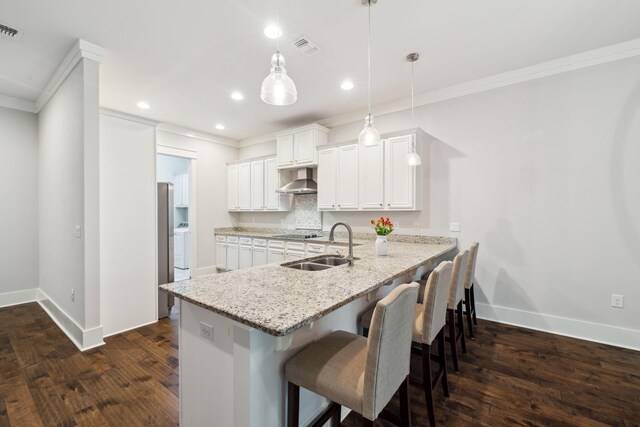 180 Blakely Drew Blvd, Santa Rosa Beach, FL 32459 - kitchen with a sink, ornamental molding, baseboards, wall chimney range hood, and dark wood finished floors