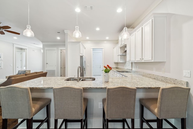 180 Blakely Drew Blvd, Santa Rosa Beach, FL 32459 - kitchen with a sink, a peninsula, white cabinets, black electric cooktop, and light stone countertops