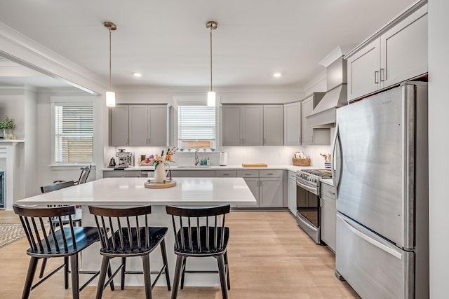 2108 Royal Tern St, Panama City, FL 32405 - kitchen featuring gray cabinets, appliances with stainless steel finishes, light wood finished floors, and a breakfast bar