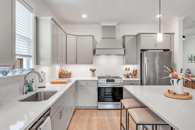 2108 Royal Tern St, Panama City, FL 32405 - kitchen with light wood-style floors, custom range hood, a sink, appliances with stainless steel finishes, and gray cabinetry