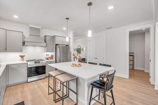 2108 Royal Tern St, Panama City, FL 32405 - kitchen featuring custom range hood, a kitchen bar, gray cabinetry, and stainless steel appliances