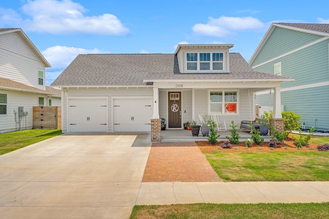 2108 Royal Tern St, Panama City, FL 32405 - view of front of house featuring covered porch, driveway, a front yard, roof with shingles, and an attached garage
