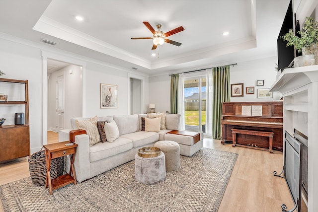 2108 Royal Tern St, Panama City, FL 32405 - living area featuring visible vents, light wood-style flooring, a raised ceiling, and ceiling fan