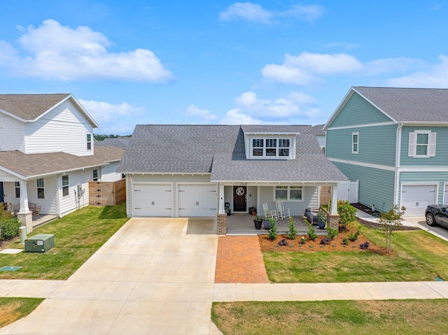 2108 Royal Tern St, Panama City, FL 32405 - traditional-style home with fence, covered porch, a front yard, roof with shingles, and driveway