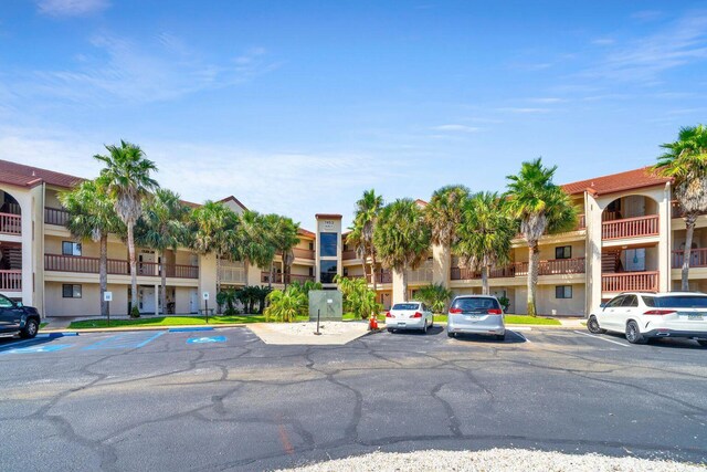 7453 Sunset Harbor Dr Apt 2-204, Navarre, FL 32566 - view of building exterior with uncovered parking and a residential view