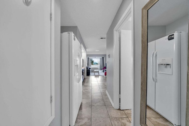 7453 Sunset Harbor Dr Apt 2-204, Navarre, FL 32566 - corridor featuring light tile patterned floors and visible vents