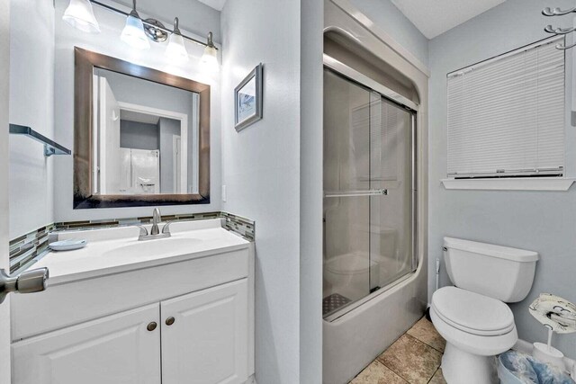 7453 Sunset Harbor Dr Apt 2-204, Navarre, FL 32566 - bathroom with toilet, vanity, and shower / bath combination with glass door