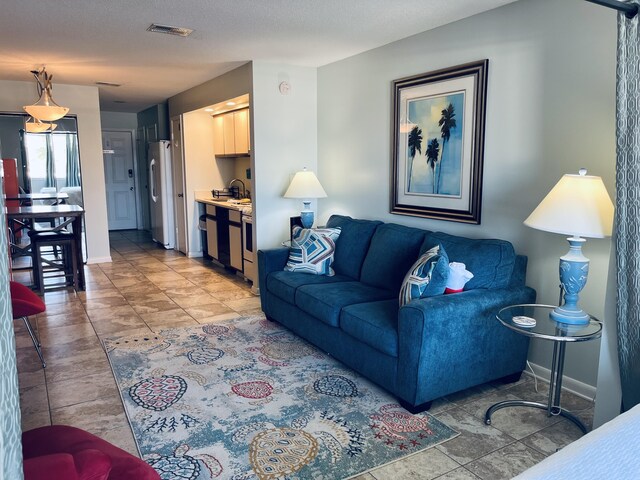7453 Sunset Harbor Dr Apt 2-204, Navarre, FL 32566 - living room featuring visible vents and baseboards