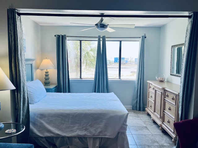 7453 Sunset Harbor Dr Apt 2-204, Navarre, FL 32566 - bedroom with light tile patterned floors and ceiling fan