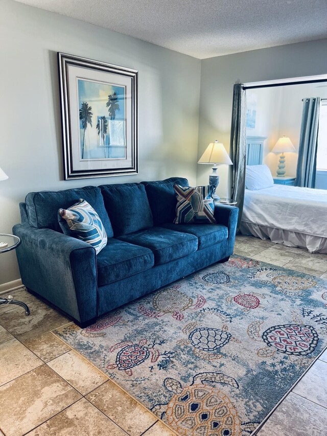 7453 Sunset Harbor Dr Apt 2-204, Navarre, FL 32566 - living area featuring a textured ceiling
