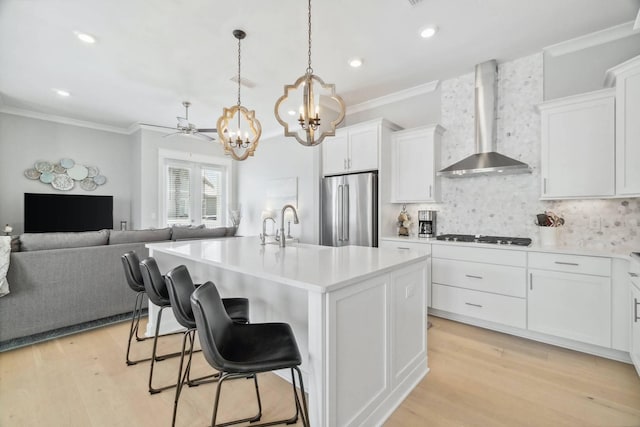 128 Wharf Ln Unit A, Inlet Beach, FL 32461 - kitchen featuring gas cooktop, ornamental molding, high end fridge, and wall chimney exhaust hood