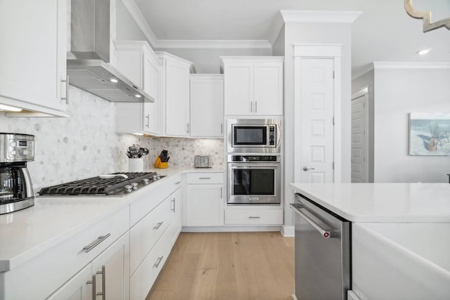 128 Wharf Ln Unit A, Inlet Beach, FL 32461 - kitchen with ornamental molding, light countertops, appliances with stainless steel finishes, and wall chimney exhaust hood