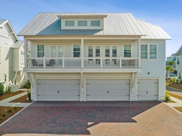 128 Wharf Ln Unit A, Inlet Beach, FL 32461 - beach home with metal roof, an attached garage, and decorative driveway