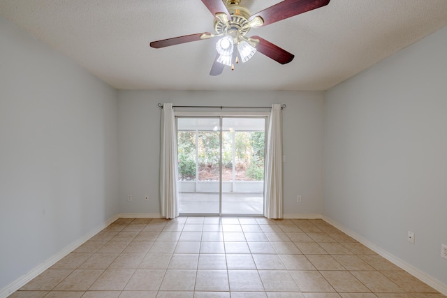 unfurnished room featuring a ceiling fan, baseboards, light tile patterned flooring, and a textured ceiling