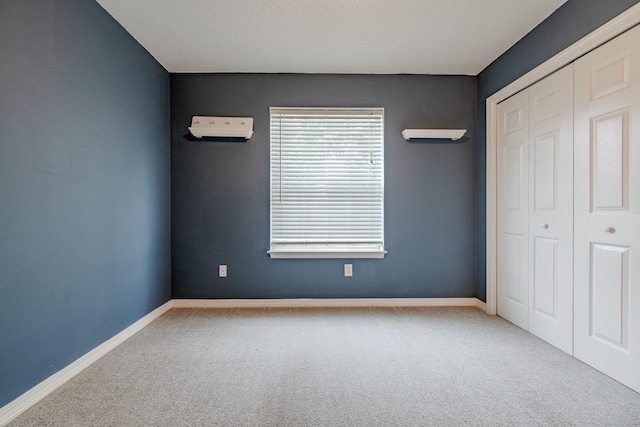 unfurnished bedroom featuring carpet, a closet, and baseboards