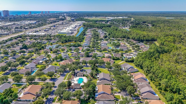 drone / aerial view featuring a water view and a residential view