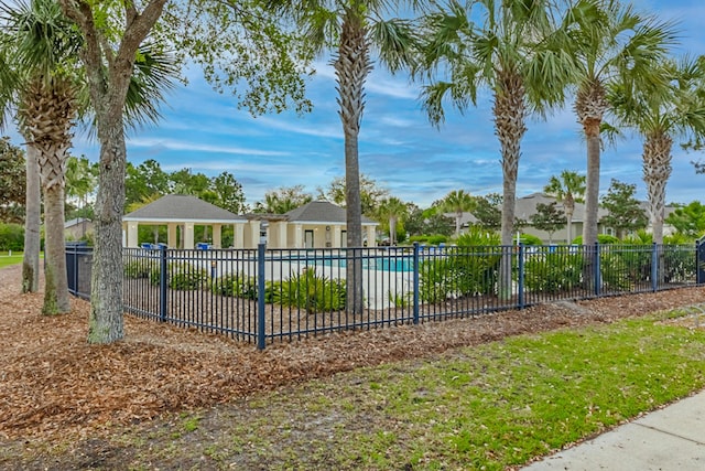 exterior space with a community pool and fence