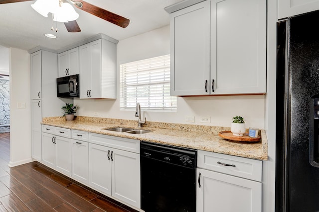 kitchen with a ceiling fan, light stone counters, dark wood finished floors, a sink, and black appliances