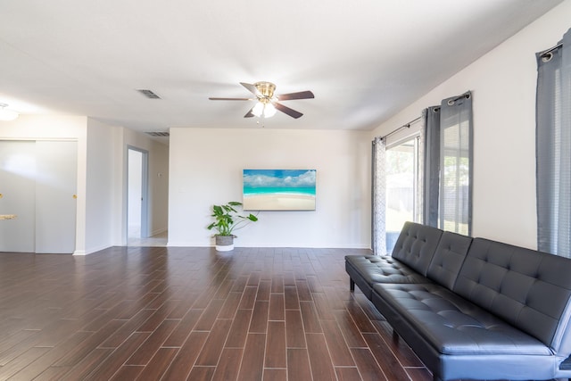 living area featuring a ceiling fan, visible vents, and wood finished floors