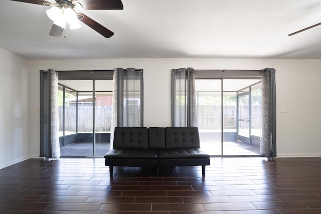 interior space featuring wood finish floors, baseboards, and ceiling fan