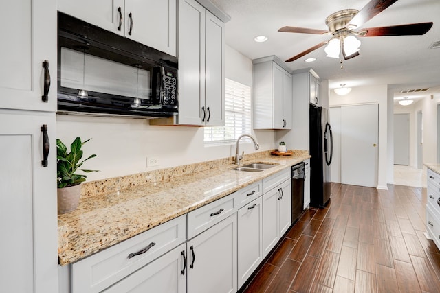 kitchen featuring ceiling fan, visible vents, black appliances, and a sink
