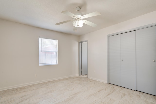 unfurnished bedroom with baseboards, a closet, and ceiling fan