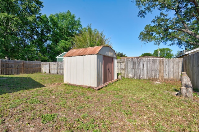 view of shed with a fenced backyard