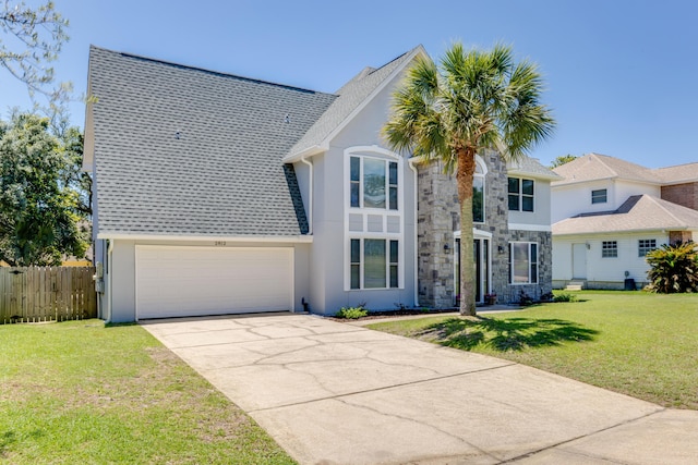 2812 Arnold Palmer Ct, Shalimar, FL 32579 - traditional home with stucco siding, driveway, and stone siding