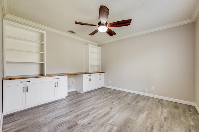 2812 Arnold Palmer Ct, Shalimar, FL 32579 - unfurnished office with built in desk, ceiling fan, light wood-style flooring, crown molding, and baseboards